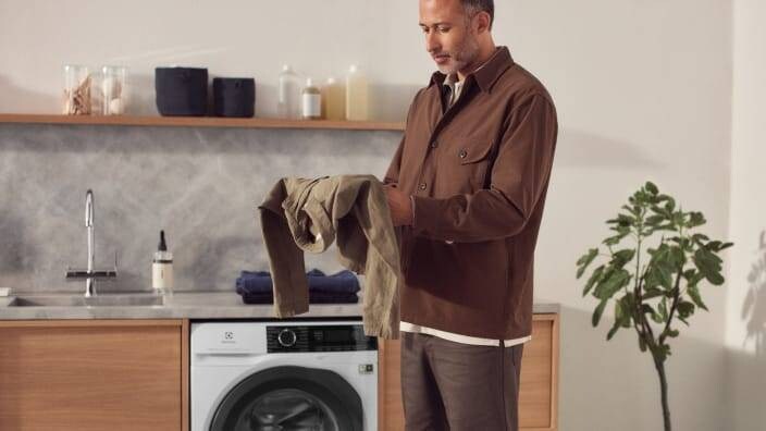 mand med en skjorte der skal vaskes